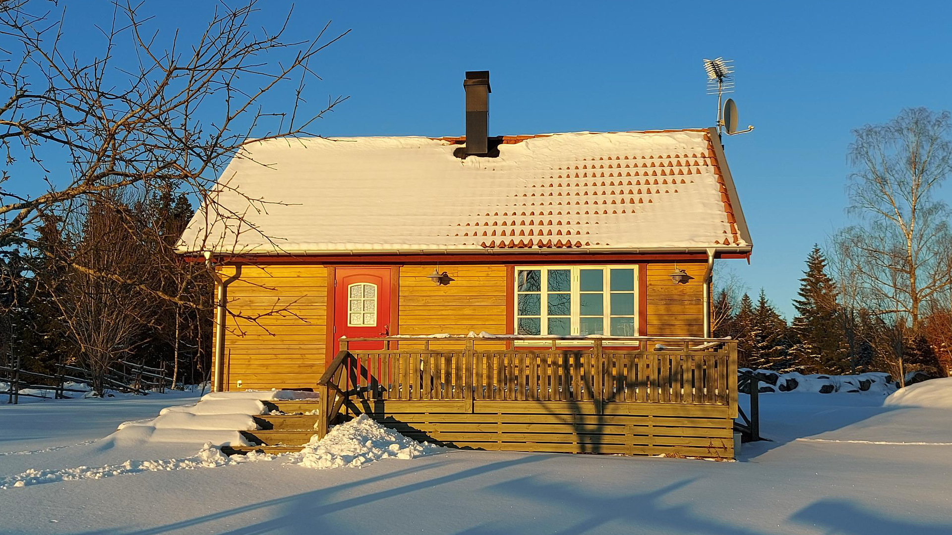 Tirad stuga i vinterlandskap och sol.